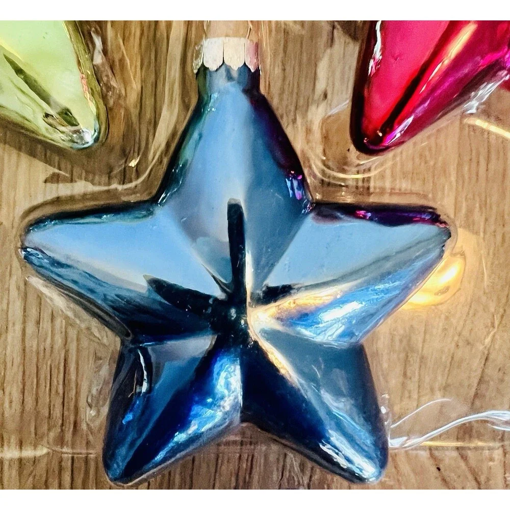 Handcrafted Glass Ornament Set features four star-shaped ornaments metallic